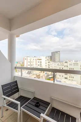 a balcony with a bench and a view of the city at Seaside View 1-bedroom apartment! in Larnaka