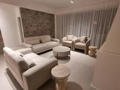 a living room with couches and chairs and a table at Karyatis Building in Nicosia