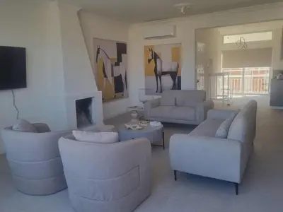 a living room with couches and a horse on the wall at Karyatis Building in Nicosia