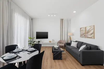 a living room with a couch and a table at Artemis 302 - Seaside Stories in Livadhia