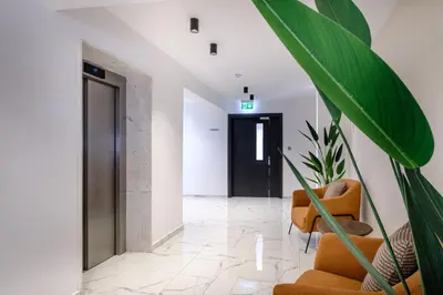 a hallway with a door and a chair and a plant at Artemis 302 - Seaside Stories in Livadhia