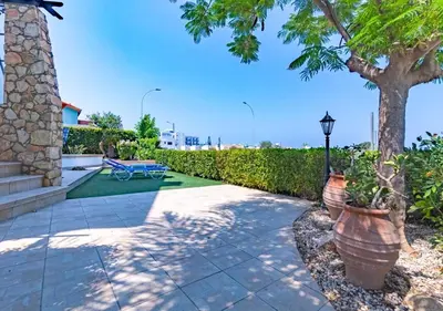 a patio with a tree and a bench and a street light at Anemone Seaview Villa DPS01 in Protaras
