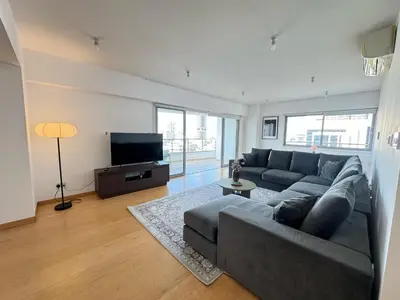 a living room with a couch and a flat screen tv at Home in Central Nicosia - Spacious Balcony in Nicosia