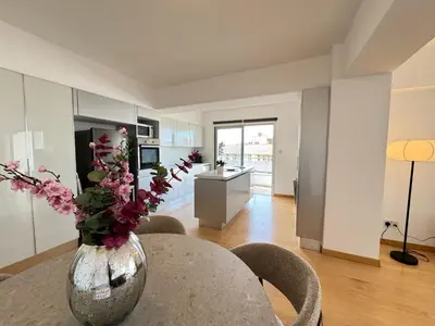a vase with flowers on a table in a room at Home in Central Nicosia - Spacious Balcony in Nicosia