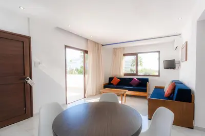 a living room with a table and a couch at Amethyst Napa Annex Apartments in Ayia Napa