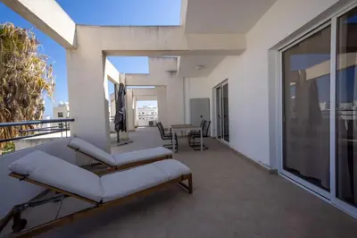 a balcony with two couches and a table on a building at Penthouse, City Center, Walking to Beach in Larnaka