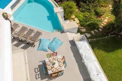 an overhead view of a swimming pool with chaise lounge chairs and a swimming pool at Protaras Seafront Villa AleMar in Protaras