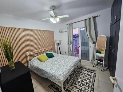 a bedroom with a bed and a ceiling fan at D&D Apartment in Paralimni