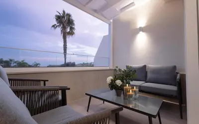a living room with a couch and a table at Luxury Marina Beach Stay in Limassol