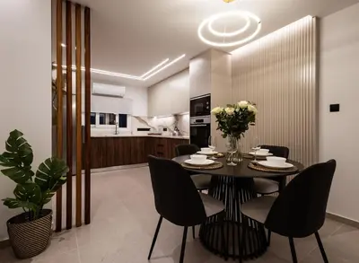 a dining room with a table and chairs at Luxury Marina Beach Stay in Limassol