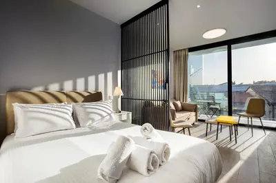 a bedroom with a bed with towels on it at Irinis 150 Urban Luxury Studios in Limassol