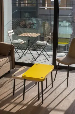 a yellow table and chairs in a room at Irinis 150 Urban Luxury Studios in Limassol