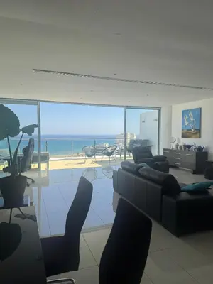 a living room with a view of the ocean at Stunning Penthouse with Sea and City View in Larnaka