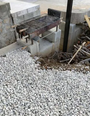 a grill sitting on top of a pile of rocks at Anastasi Tiny Homes- Mountain Views, Garden & Terrace, Pet Friendly in Kakopetria