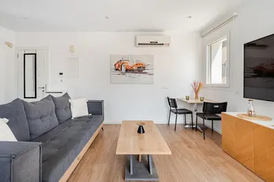 a living room with a couch and a table at The Central Flat Limassol in Limassol