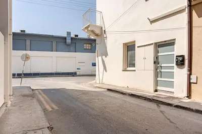 an empty street in front of a building at The Central Flat Limassol in Limassol
