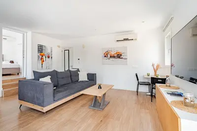 a living room with a couch and a table at The Central Flat Limassol in Limassol