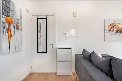 a living room with a couch and a door at The Central Flat Limassol in Limassol