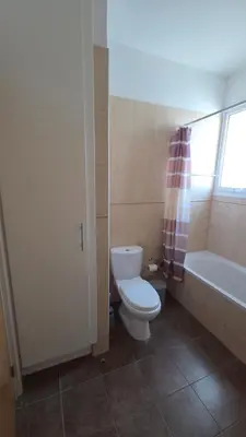 a bathroom with a toilet and a tub and a sink at Chrystallia Protaras in Paralimni