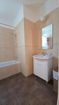 a bathroom with a sink and a tub and a mirror at Chrystallia Protaras in Paralimni