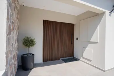 a door in a hallway with a potted plant at Raise Cityscape Limassol Suites in Limassol