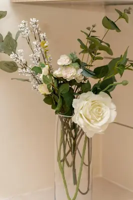 a vase filled with white roses and other flowers at 2 bedroom house near the beach in Limassol