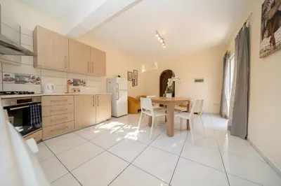 a kitchen with a table and a table and chairs at 2 bedroom house near the beach in Limassol