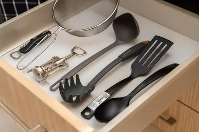 a drawer with cooking utensils in a kitchen at 2 bedroom house near the beach in Limassol