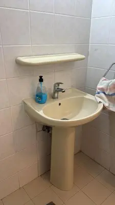 a bathroom sink with a soap bottle on it at Larnaca Ancient View Rooms With Smart TV & Netflix in Larnaka