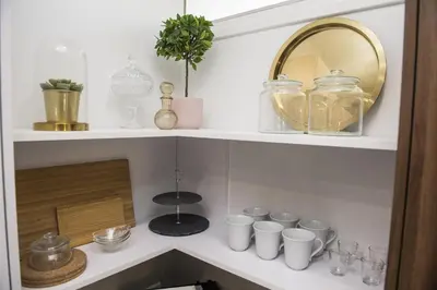 a shelf with cups and a mirror in a kitchen at STAY Glam Skin Studio in Nicosia