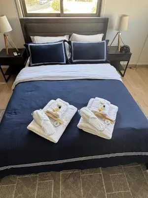 a bed with white towels on top of it at Elegant Escape in Nicosia in Nicosia
