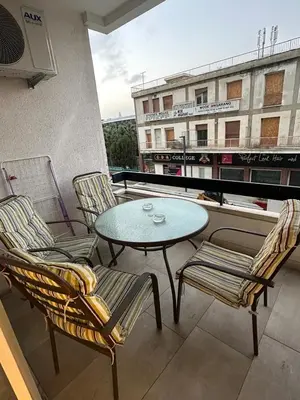 a patio with a table and chairs on a balcony at Near Finikoudes Beach 15 in Larnaka