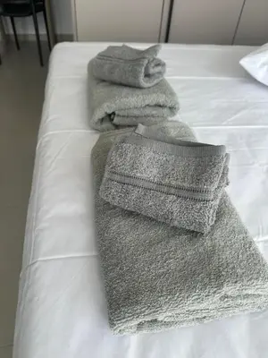 a group of towels sitting on top of a bed at Nesseus Lux Suites - Near Unic & EUC in Ayios Dhometios