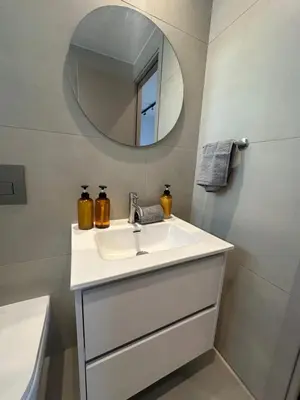 a bathroom with a sink and a mirror at Nesseus Lux Suites - Near Unic & EUC in Ayios Dhometios