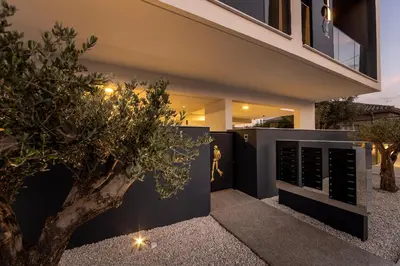 a home with a tree in the front yard at Nesseus Lux Suites - Near Unic & EUC in Ayios Dhometios