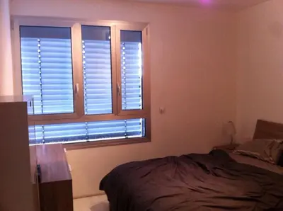 a bedroom with a bed and a window with shutters at Neoptolemou Residences in Nicosia