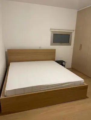 a bedroom with a bed in a room with a window at Neoptolemou Residences in Nicosia