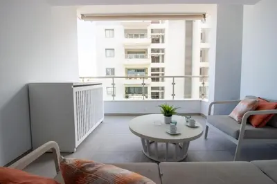 a living room with a table and a large window at Modern City Retreat - Balcony and Chic Design in Nicosia
