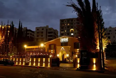 a building with a lit up sign on it at night at Poseidon North Ciprus, Tatlisu