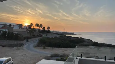 a road leading to the beach with the sunset in the background at Poseidon North Ciprus, Tatlisu