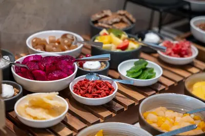 a table topped with bowls of different types of food at Warner Boutique Hotel-Adults Only in Larnaka