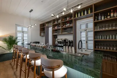 a bar in a restaurant with a row of stools at Warner Boutique Hotel-Adults Only in Larnaka