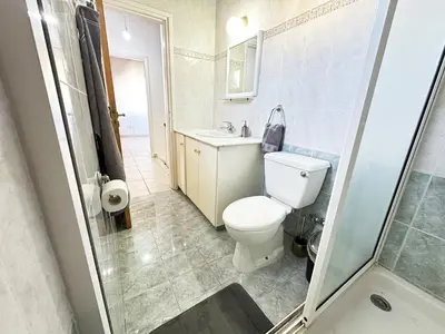 a bathroom with a toilet and a sink and a shower at Serenity in the Sun - Holiday Apt - Larnaca in Larnaka
