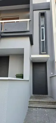a white building with a garage and a door at Skoufa 21 - Luxury Apartment -Breakbooking CY in Limassol