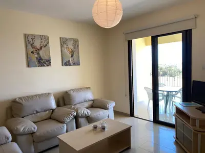 a living room with a couch and a table at Kyklades Resort & Spa in Paralimni