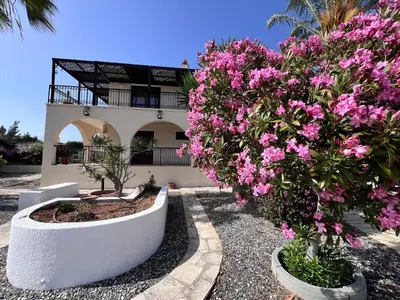 a house with pink flowers in front of it at Charming Erimi Villa with Private Pool and Garden View in Erimi