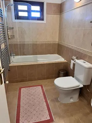 a bathroom with a toilet and a bath tub at Charming Erimi Villa with Private Pool and Garden View in Erimi