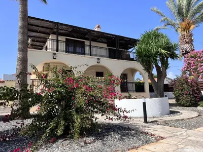 a house with pink flowers in front of it at Charming Erimi Villa with Private Pool and Garden View in Erimi