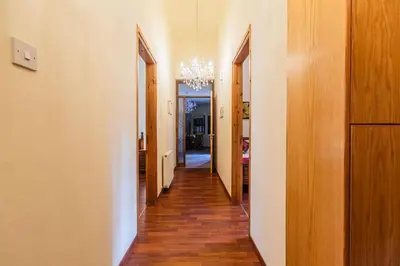 an empty hallway with a chandelier in a house at Villa Penelope Platres in Kato Platres