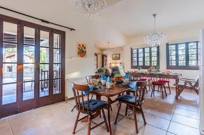 a dining room with a table and chairs at Villa Penelope Platres in Kato Platres